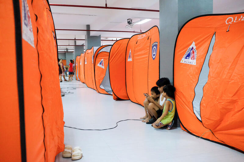 A total of 118 families from Barangay Bagong Silangan, Quezon City, Philippines, seek shelter at the Bagong Silangan Evacuation Center on November 17, 2024, due to the expected flooding in low-lying areas cause by Super Typhoon Man-yi, local name Pepito, near the Marikina River.