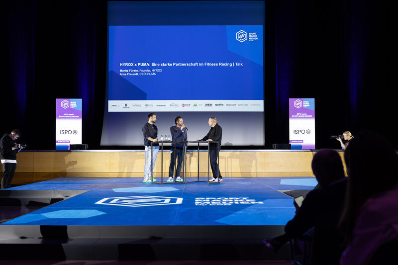 Moritz Fürste, Gründer HYROX, Arne Freundt, CEO Puma SE, beim Sport Marke Medien am Media Day der ISPO 2024, einer Fachmesse und Business-Festival für die Sport-, Lifestyle-, Health- und Techindustrie am 02.12.2024 in München.   --    Moritz Fuerste, Founder HYROX, Arne Freundt, CEO Puma SE, at the Sport Marke Medien at the Media Day of the ISPO 2024, a trade fair and business festival fot the sports, lifestyle and tech industry on December 2nd, 2024 in Munich, Germany.