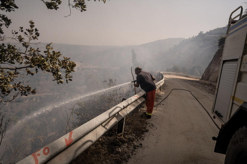 Calabria Verde operator working in the hills in Santa Venere, Reggio Calabria, Italy on July 25, 2023.