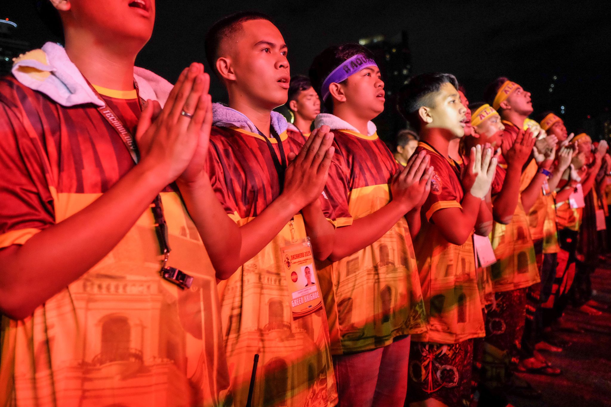 Devotees of the Jesus Nazarene attend the Misa Mayor, a midnight mass before the Translación, on January 9, 2025, at the Quirino Grandstand in Manila City, Philippines. During the Translación, devotees walk barefoot, jump, and clutch at the cross carried by the life-size statue of Jesus Nazarene, believing it to bring miracles and healing.  The image of the Jesus Nazarene is believed to have been brought to the Philippines by missionaries of the Order of Augustinian Recollects from Mexico in 1606.